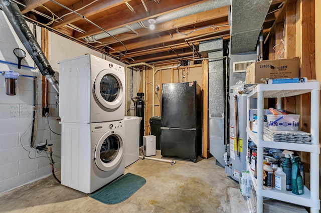 laundry area featuring stacked washer and clothes dryer