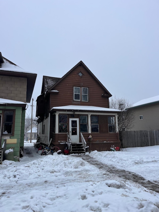 view of snow covered back of property