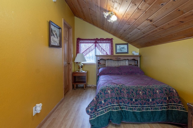 bedroom with wood-type flooring, wood ceiling, and vaulted ceiling