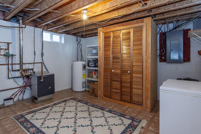 basement with refrigerator, electric panel, and water heater