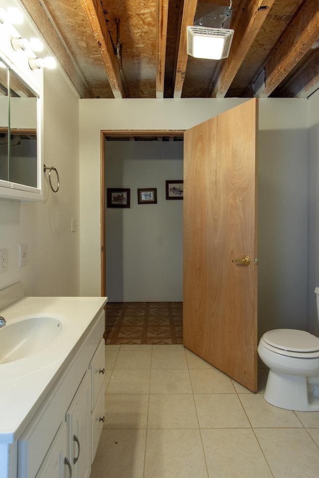 bathroom with tile patterned floors, vanity, and toilet