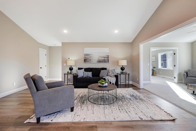 living room with lofted ceiling and hardwood / wood-style flooring