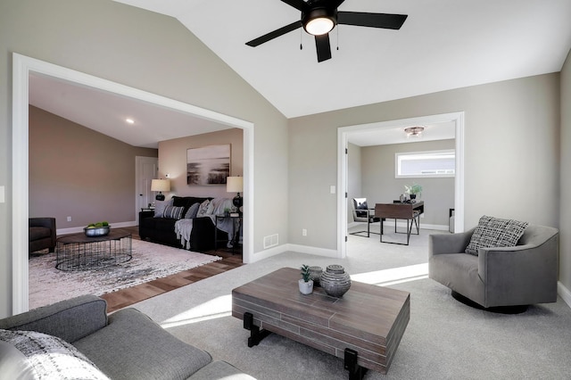 living room with ceiling fan, lofted ceiling, and carpet floors