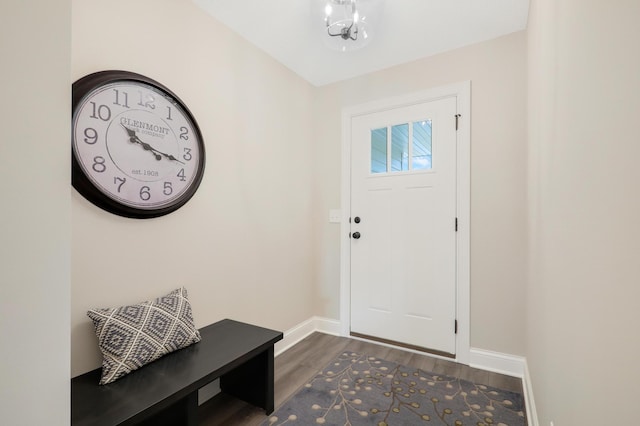 entrance foyer with dark wood-type flooring and a notable chandelier