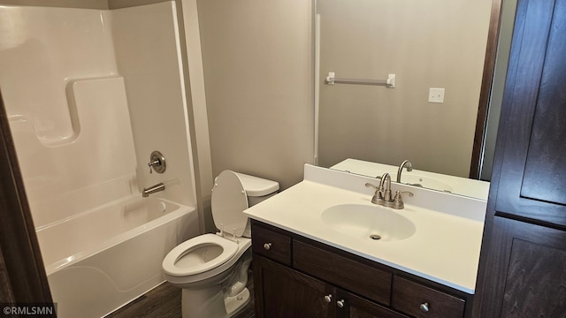 full bathroom with toilet, hardwood / wood-style floors, vanity, and bathing tub / shower combination