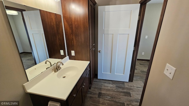 bathroom with hardwood / wood-style floors and vanity