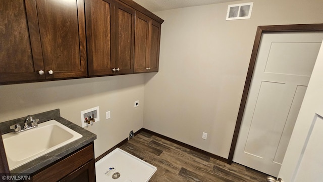 clothes washing area with cabinets, sink, washer hookup, dark hardwood / wood-style floors, and hookup for an electric dryer