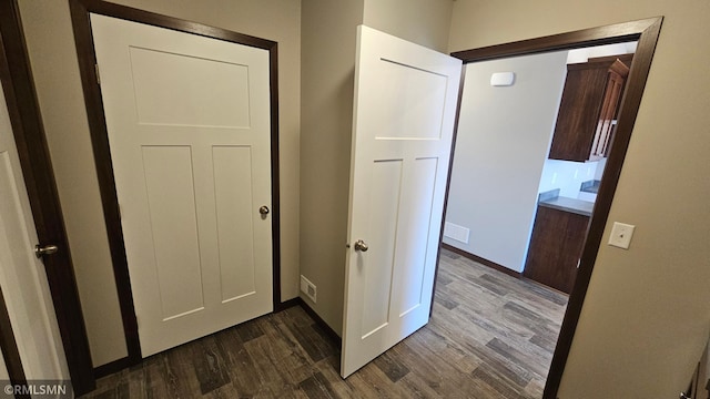 corridor featuring dark wood-type flooring