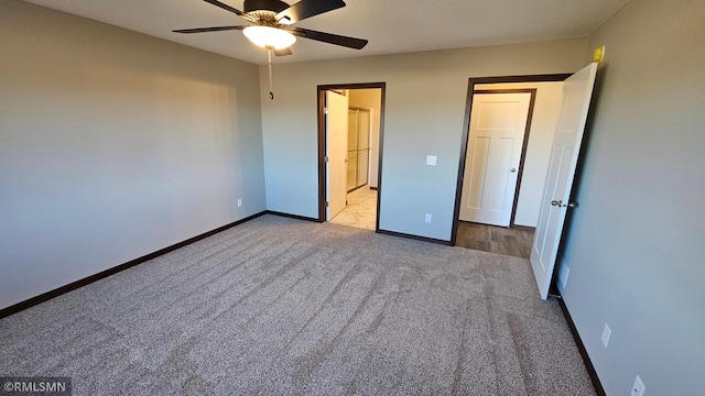 unfurnished bedroom featuring light carpet and ceiling fan