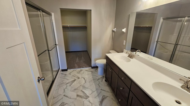 bathroom featuring toilet, vanity, and walk in shower