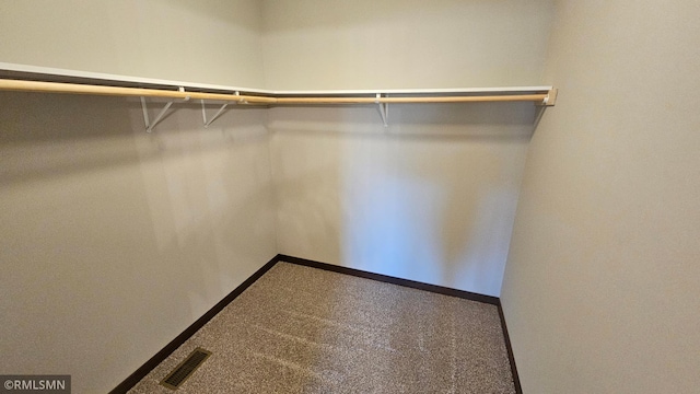 walk in closet featuring carpet