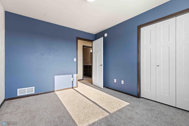 unfurnished bedroom featuring carpet floors and a closet