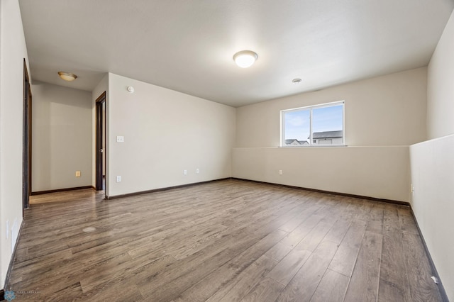 spare room with hardwood / wood-style flooring