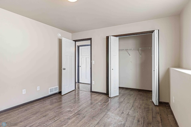 unfurnished bedroom featuring hardwood / wood-style flooring and a closet