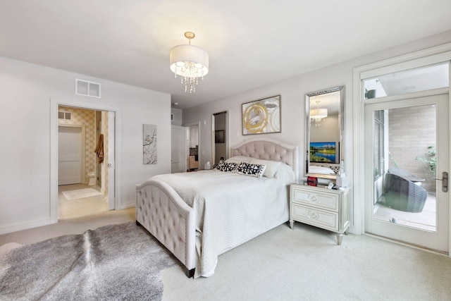 carpeted bedroom with a chandelier and ensuite bathroom