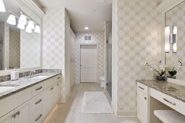 bathroom featuring toilet, vanity, tile patterned floors, and walk in shower