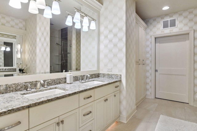 bathroom with tile patterned floors, vanity, and an enclosed shower