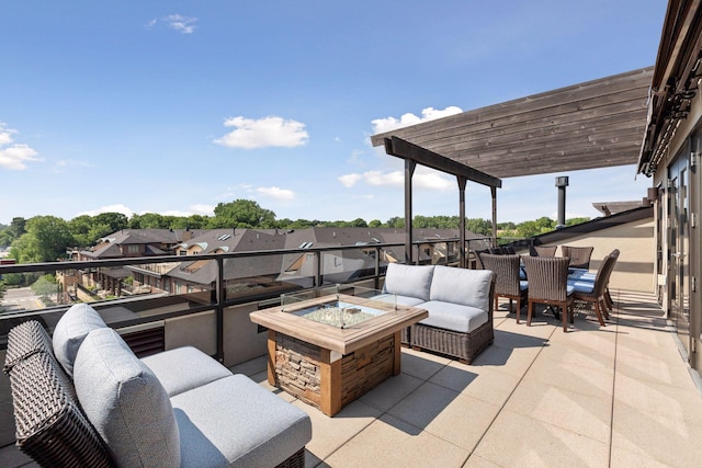 view of patio featuring a pergola, a balcony, and an outdoor living space with a fire pit