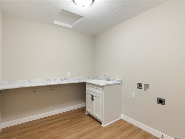 laundry room featuring hookup for an electric dryer, hookup for a washing machine, cabinets, sink, and light hardwood / wood-style floors