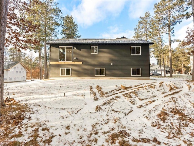 view of snow covered rear of property