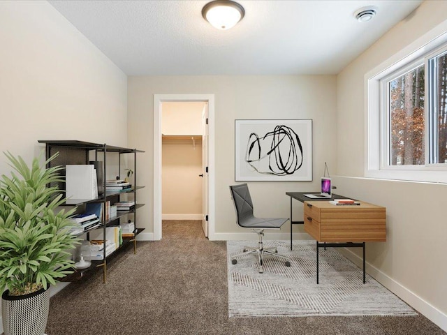 carpeted office with visible vents and baseboards