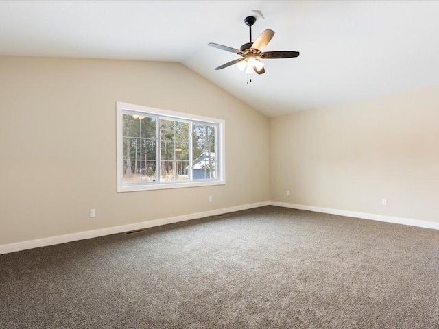 unfurnished room featuring baseboards, visible vents, a ceiling fan, vaulted ceiling, and carpet floors