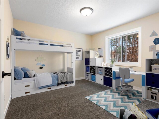 carpeted bedroom featuring a textured ceiling and baseboards