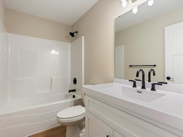 full bathroom with toilet, bathtub / shower combination, wood finished floors, and vanity