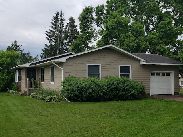 view of property exterior featuring a garage and a yard