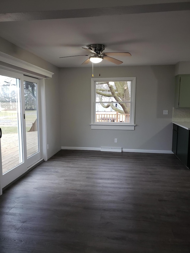 unfurnished room with ceiling fan and dark hardwood / wood-style flooring