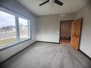 unfurnished room with carpet and ceiling fan