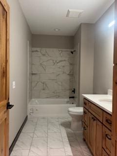 full bathroom with vanity, toilet, and tiled shower / bath combo