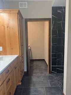 bathroom with vanity and walk in shower