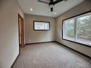 interior space with ceiling fan and light colored carpet