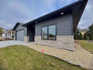 view of property exterior with a yard and a garage