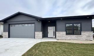 view of front of home featuring a front lawn and a garage