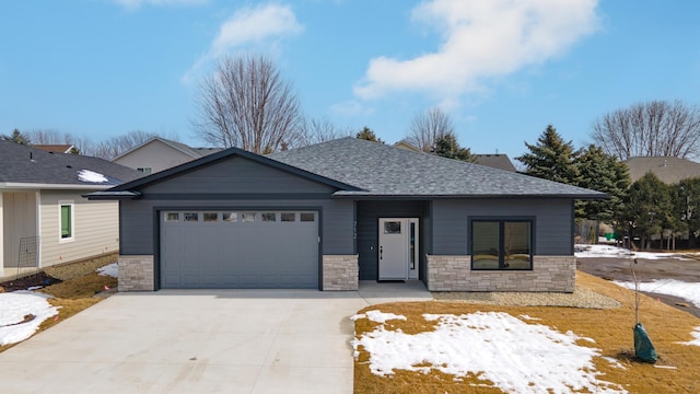 view of front of house with stone siding, an attached garage, roof with shingles, and driveway