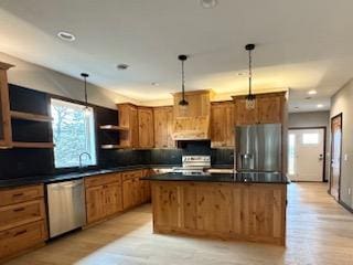 kitchen with plenty of natural light, dark countertops, appliances with stainless steel finishes, open shelves, and hanging light fixtures