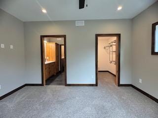 unfurnished bedroom with baseboards, carpet floors, visible vents, and recessed lighting