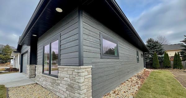 view of side of home featuring stone siding