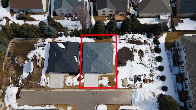snowy aerial view with a residential view