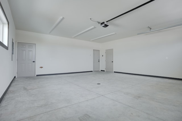 garage with a garage door opener and baseboards