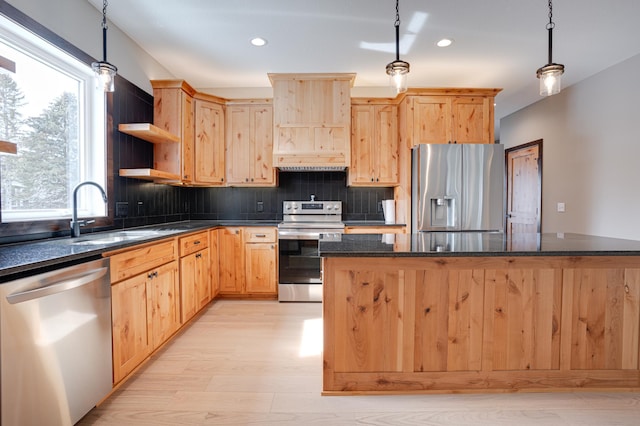kitchen featuring decorative backsplash, a sink, light brown cabinetry, and appliances with stainless steel finishes