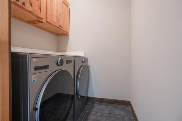 laundry area with tile patterned floors, cabinet space, washing machine and dryer, and baseboards