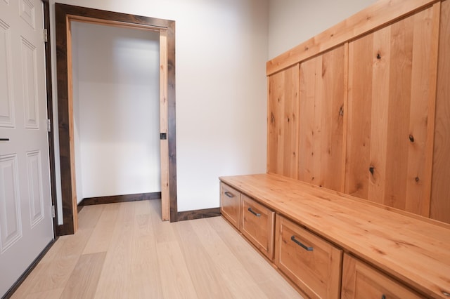 mudroom with baseboards and light wood-style flooring