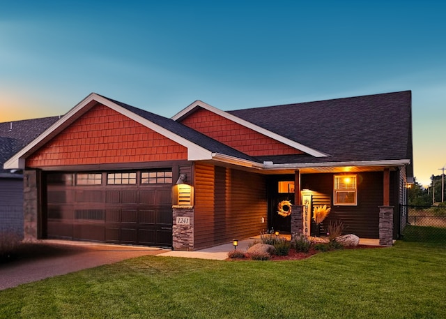 craftsman-style home with a yard and a garage