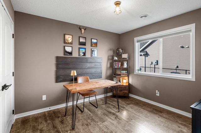 office featuring hardwood / wood-style floors and a textured ceiling