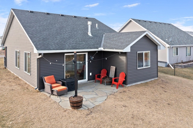 back of house with a yard, a fire pit, and a patio