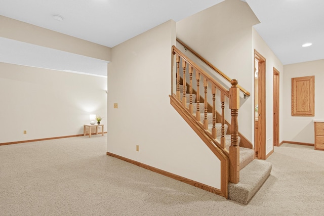 staircase with baseboards, carpet floors, and recessed lighting