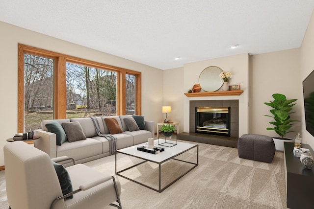 carpeted living area with a fireplace